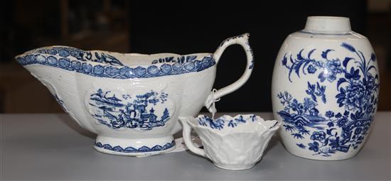 A Derby blue and white printed sauceboat, a Worcester fence pattern blue and white geranium moulded butter boat